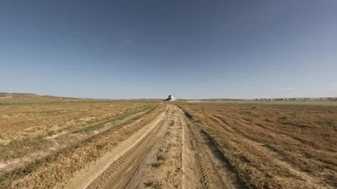 Off-road vehicle navigating dirt path through open landscape at high speed Stock Footage 341974954