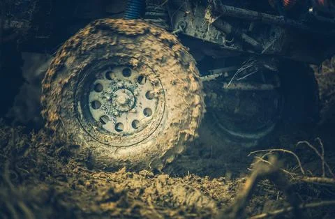 Off-road Vehicle Navigating Through Muddy Terrain During the Late Afternoon.. Stock Photos