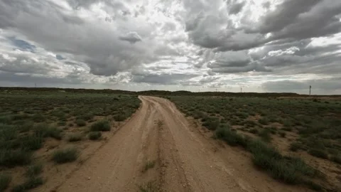 Off-road vehicle navigating a winding dirt path through open landscape Stock Footage 341791209
