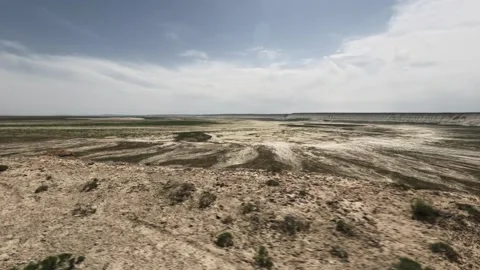 Off-road vehicle view of expansive dry landscape with distant hills and clouds Stock Footage 340251964