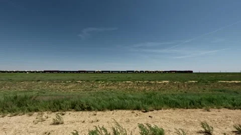 Off-road vehicle view of train passing through open grassland landscape Stock Footage 340411318