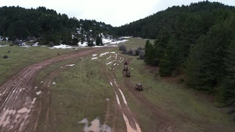 Off road vehicles crossing muddy mountain trail with water puddles Stock Footage 344096532