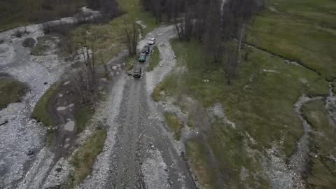 Off-road vehicles driving on a mountain dirt road in Arkhyz Stock Footage 337712940