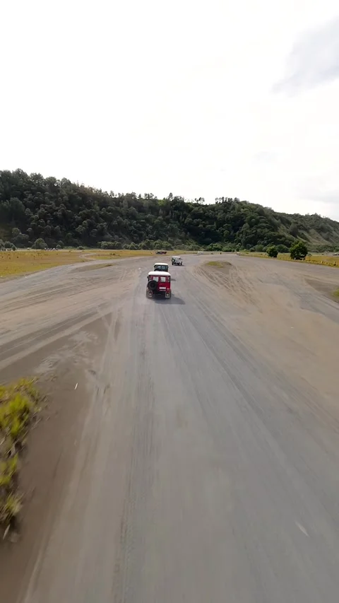 Off-road vehicles driving through volcanic plains near Mount Bromo, Indonesia Video stock 336682085