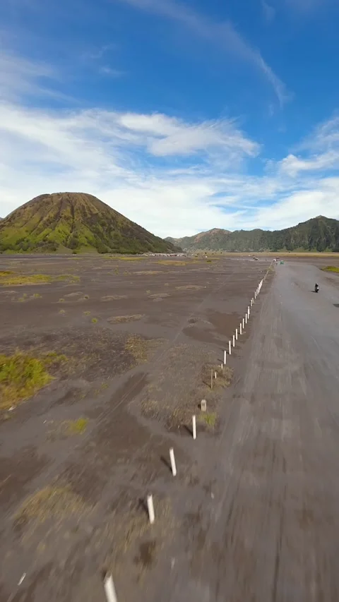 Off-road vehicles driving through volcanic plains near Mount Bromo, Indonesia Video stock 336682387