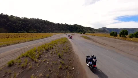 Off-road vehicles driving through volcanic plains near Mount Bromo, Indonesia Video stock 336682472