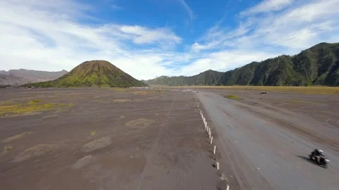 Off-road vehicles driving through volcanic plains near Mount Bromo, Indonesia Stock-Footage 336682684