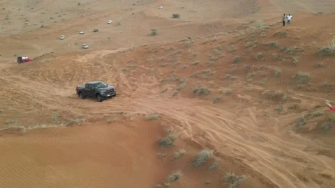 Off-road vehicles navigate sand dunes during a desert safari in the UAE. Stock Footage 333469817