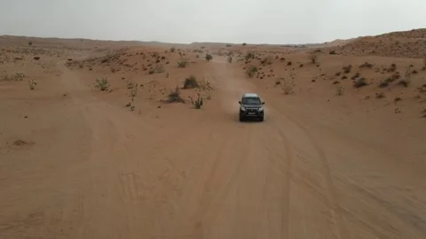 Off-road vehicles navigate sand dunes in the Arabian Desert in the UAE. Stock Footage 333469953