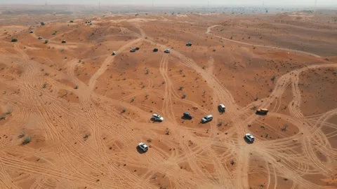 Off-road vehicles navigate sand dunes during a desert safari in the UAE. Stock Footage 333482047