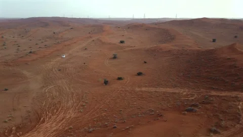 Off-road vehicles navigate sand dunes during a desert safari in the UAE. Stock Footage 333482092