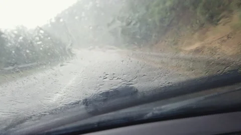 Road view through car window with rain drops, Driving in rain. Stock Footage 145231521