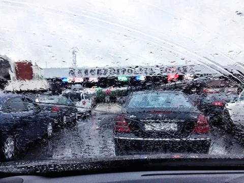 Road view through car window with rain drops, Driving in rain Stock Photos