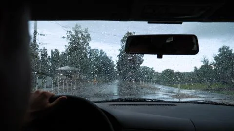 Road view through car window with rain drops Stock Photos