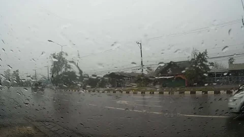 Road view through car windshield with rain drops, Waiting for cross the road Stock Footage 74839135