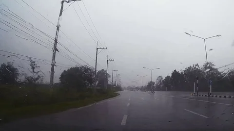 Road view through car windshield with rain drops, Driving in rain. Stock Footage 78758724