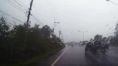 Road view through car windshield with rain drops, Driving in rain. Stock Footage 78758980