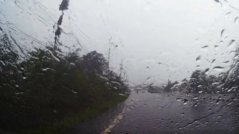 Road view through car windshield with rain drops, Driving in rain. Stock Footage 79331597