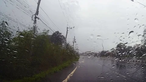 Road view through car windshield with rain drops, Driving in rain. Stock Footage 79587168