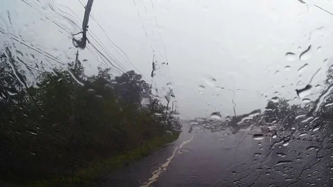 Road view through car windshield with rain drops, Driving in rain. Stock Footage