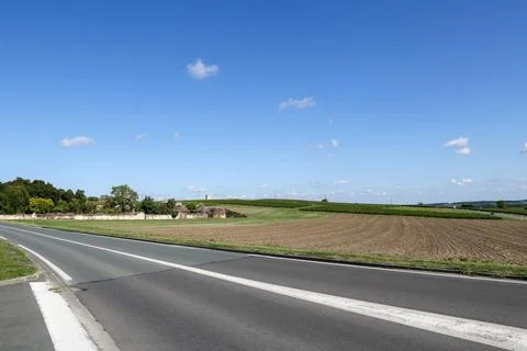 A road with a white line down the middle and a blue sky above Foto stock