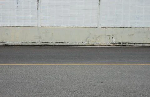 A road with a white wall in the background Foto stock