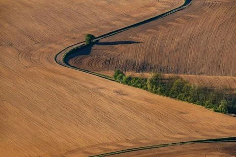 Road winding through spring fields on aerial photo. Foto stock