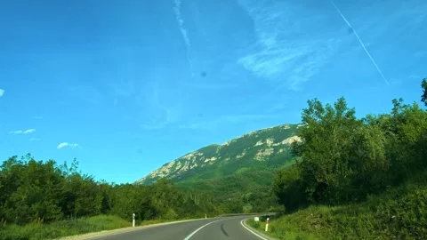 Road winds through green hills under blue sky. Mount Rtanj Area, Serbia Stock Footage 340898504