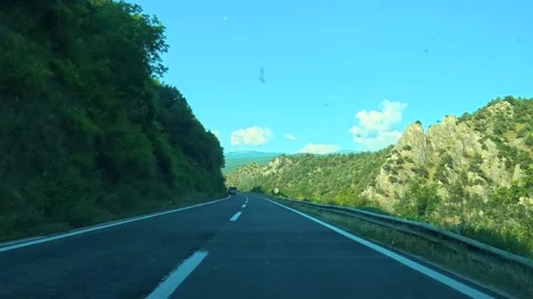 Road winds through green mountains and blue sky. Macedonia 動画素材 338346921