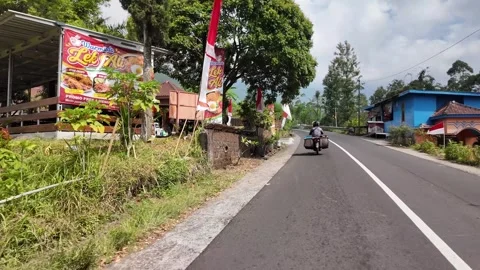 Road winds through lush green hills Stock Footage 345193673