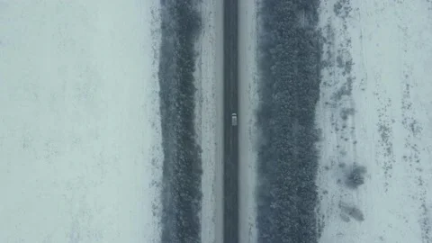 Road in the winter forest. Heavy snowfall. Aerial View. Stock Footage 144533505