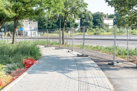 Road work ahead construction site barrier with metal protective fence Stock Photos