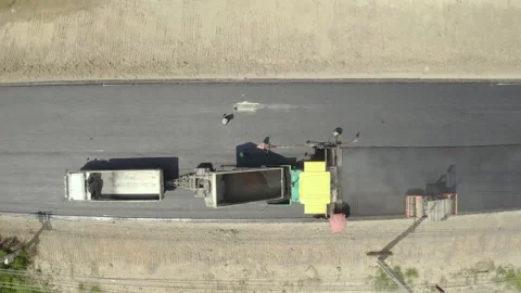 Road work. Large machine work on a new road construction site. Stockbeeldmateriaal 202226433