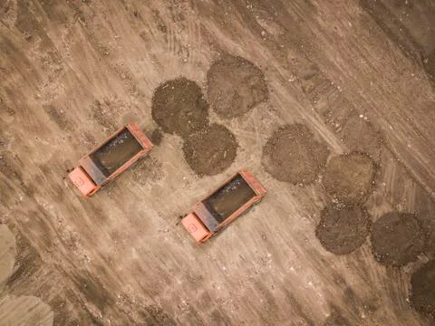 Road work. Large machine work on a new road construction site. Aerial view from Stock Photos