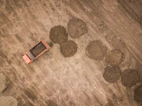 Road work. Large machine work on a new road construction site. Aerial view from Stock Photos