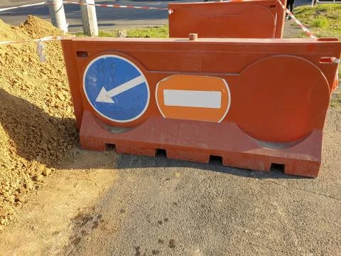 Road work on the sidewalk. Warning road signs on the fence around the pit on Foto stock