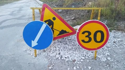 Road Work Signs that Indicate Construction Areas and Set Specific Speed Limits 스톡 사진