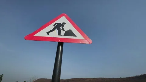 Road Work Warning Sign Against Clear Sky Stock Footage 337437763