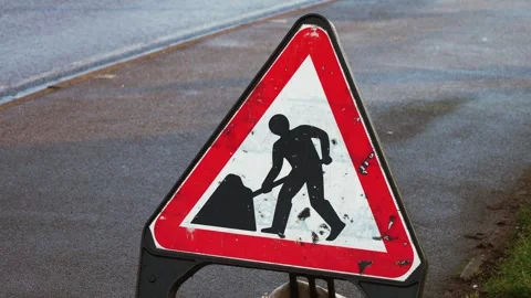 Road work warning sign in United Kingdom. Traffic regulation board indicating Stock Footage 311524215