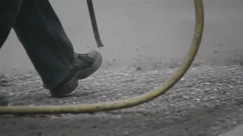 Road worker cleaning asphalt Stock-Footage 24821632