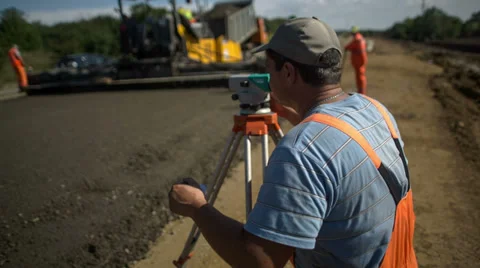 Road worker looks through a level 動画素材 38523396