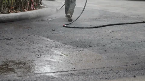 Road worker spraying tar near curb 스톡 동영상 24822013