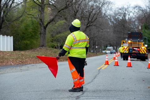 A road worker stands on the road Stock Photos