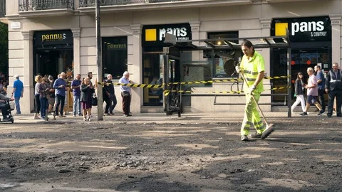 Road worker sweeps asphalt during pavement repair Stock Footage 118321086