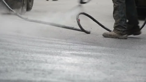 Road worker using hose Stock Footage 24821873