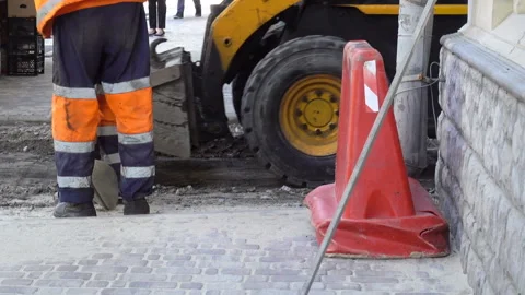 Road workers and excavator work in the city Stock Footage 128351077