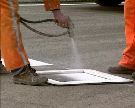 Road workers applying road marking to the road using a template Stock Footage 39781750