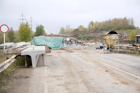 Road workers concrete the superstructure opposite heavy traffic . Stock Photos
