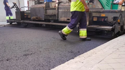 Road workers during paving process with asphalt paving machine 스톡 동영상 253231158