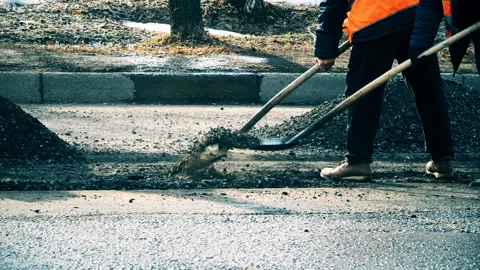 Road workers perform road repairs Stock Footage 105065003